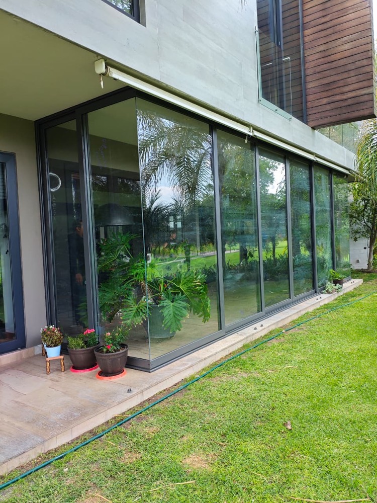 Cancelería de aluminio con vista al jardín en una residencia de Querétaro